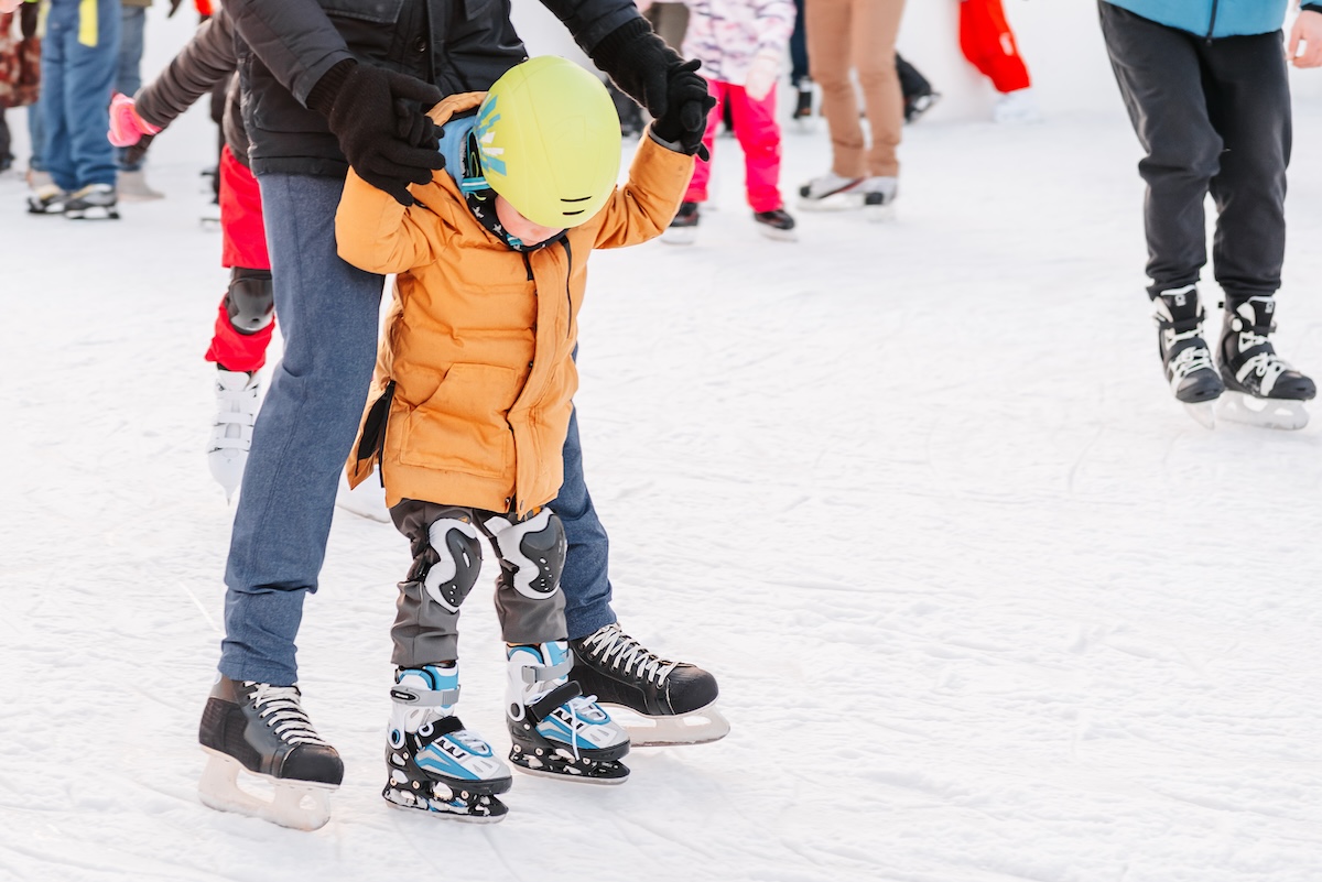 Funny moment fell on the ice skating rink. Activity, Adult, Child, Childhood, Daughter. Mom with baby boy 3-5 years old, learn train, ride winter city rink, ice skating.